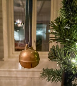 Dombjelle i messing med fløyelsbånd