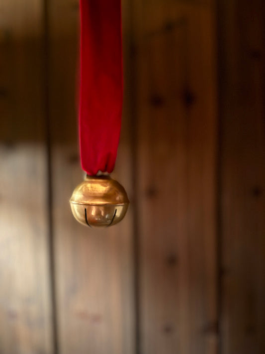 Dombjelle i messing med fløyelsbånd