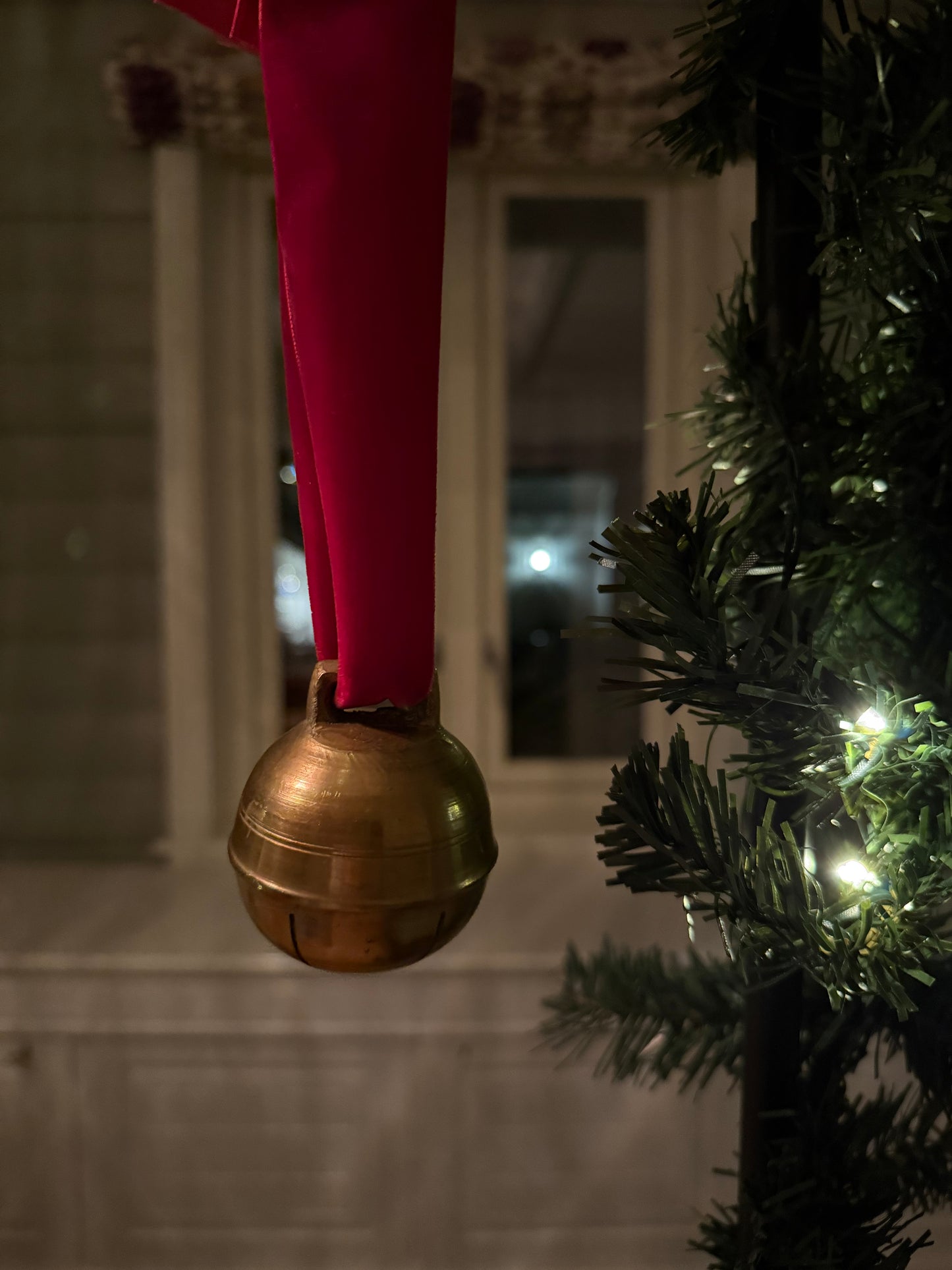 Dombjelle i messing med fløyelsbånd